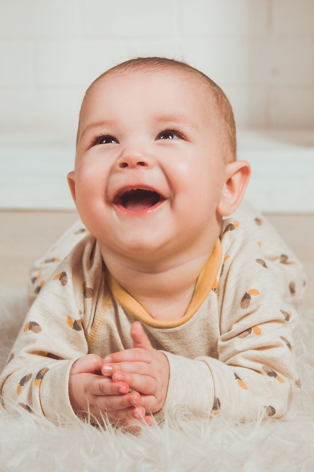 Baby laughing and playing on the floor
