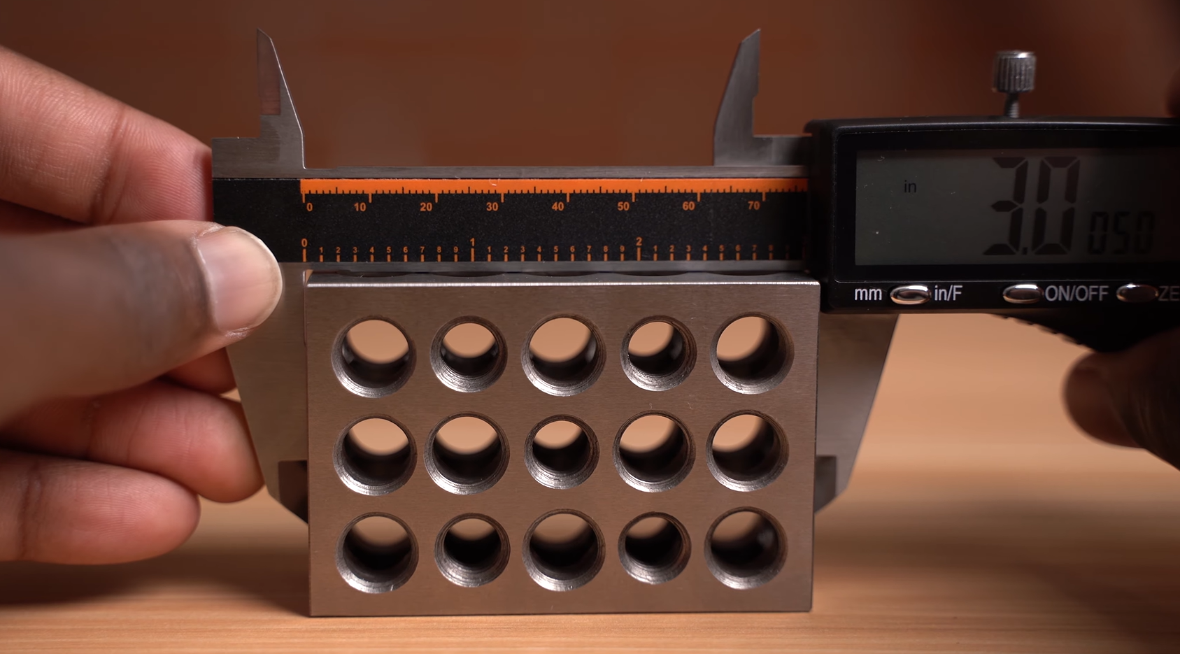 using Hardell digital caliper to measure the outside of a 3 inch block
