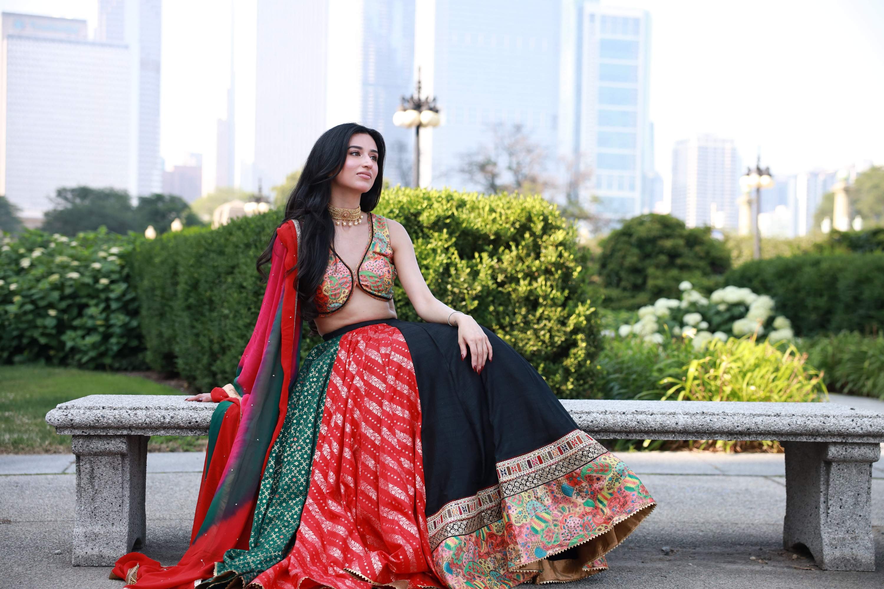 A beautiful woman is elegantly dressed in a timeless lehenga choli, featuring intricate embroidery and vibrant hues, set against a charming Indian backdrop. The flowing skirt showcases skilled craftsmanship, making it perfect for special occasions like weddings and festivals.