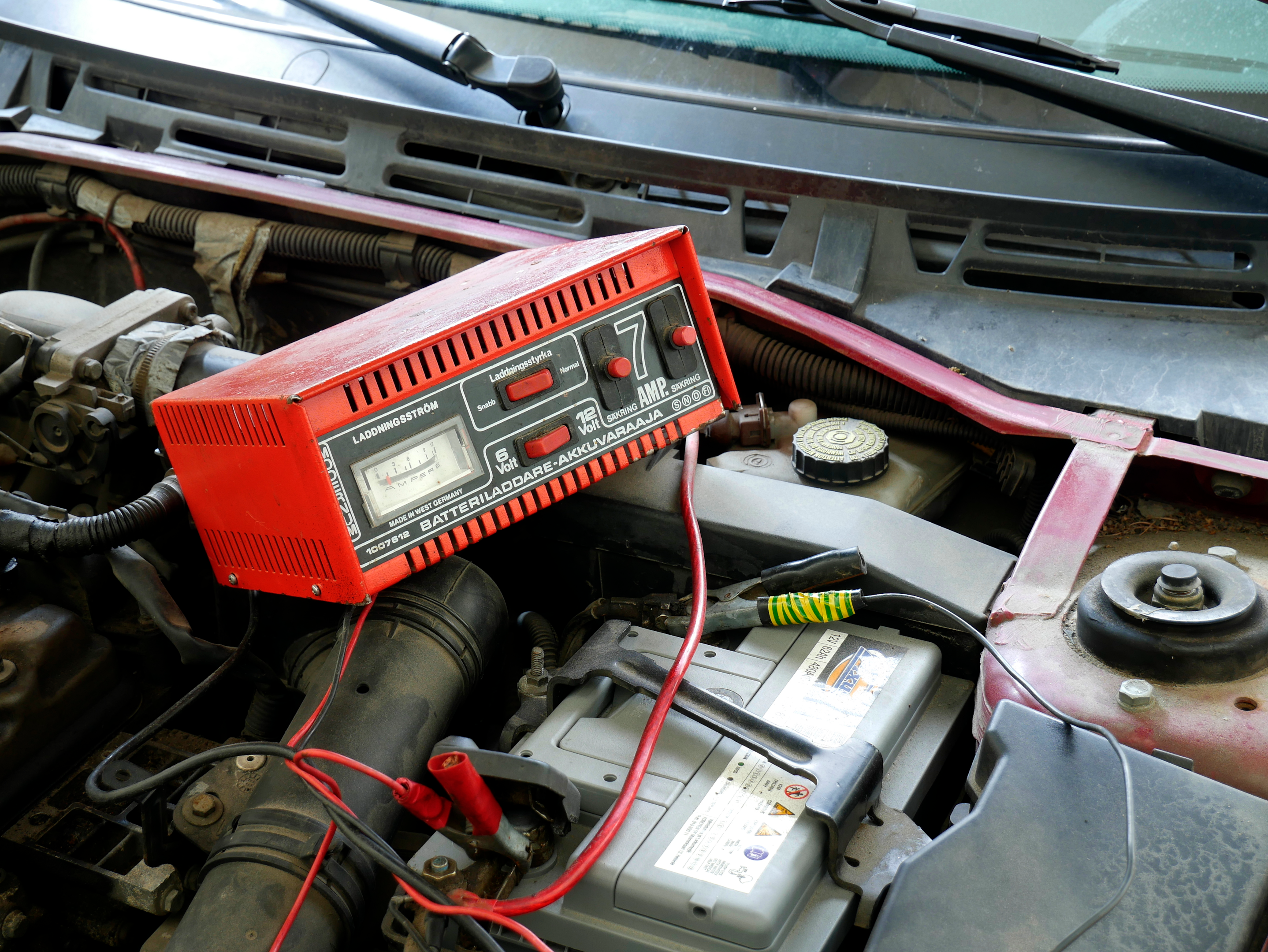 A car with a trickle charger connected to its battery