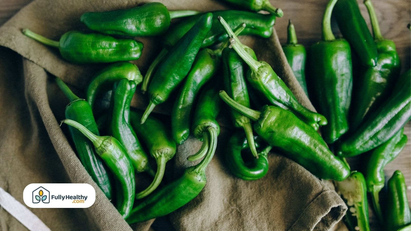 Fresh green jalapeño peppers from the pepper plant placed on a kitchen cloth