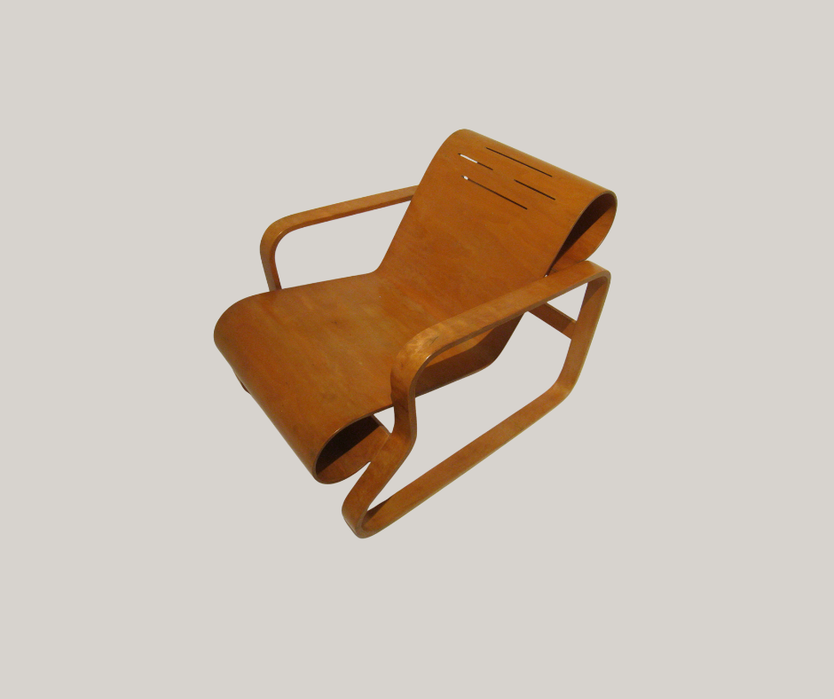Brown bent-plywood lounge chair with continuous curved seat and back, supported by a sculptural bent-wood frame.