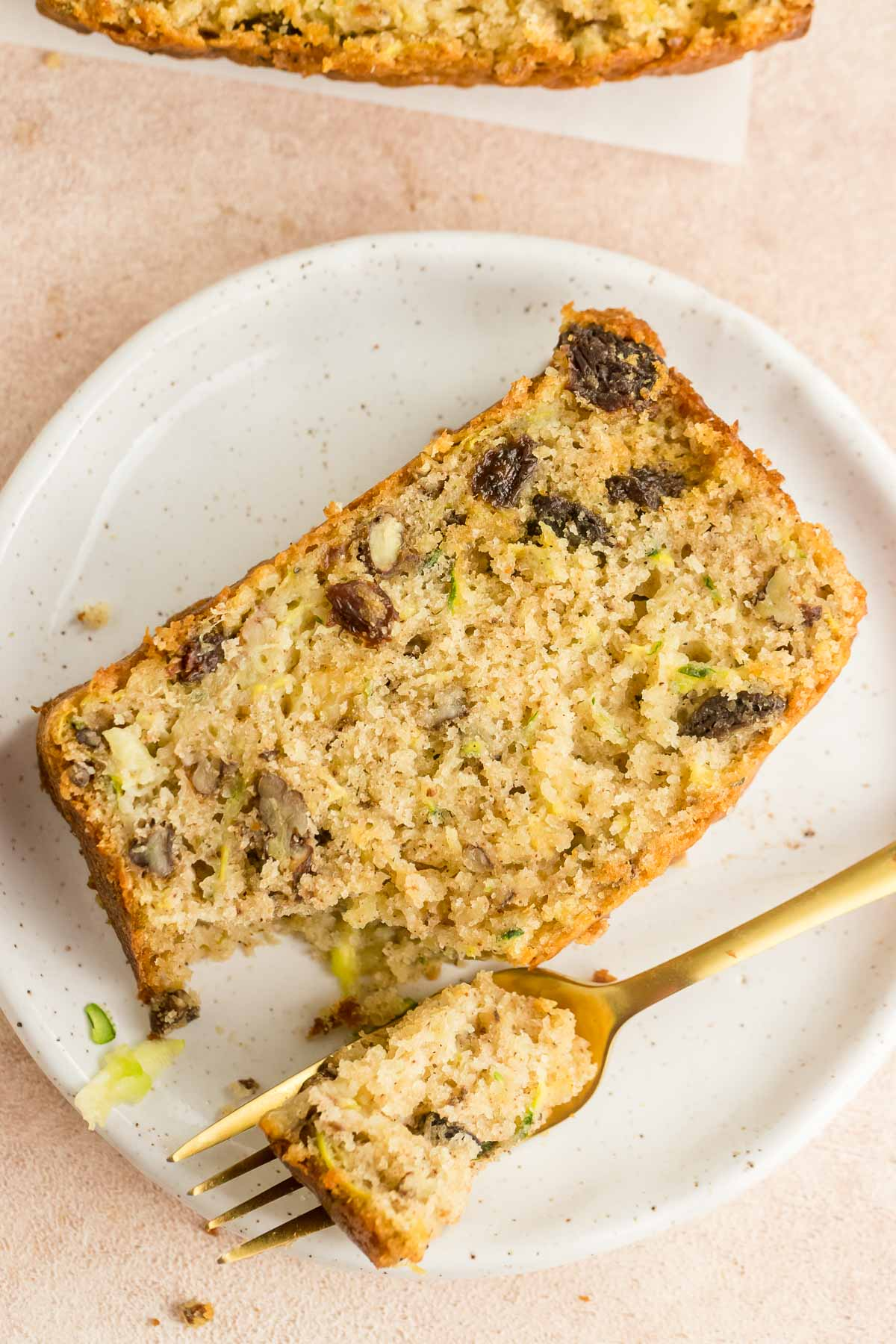 slice of zucchini pineapple bread on a plate with a fork