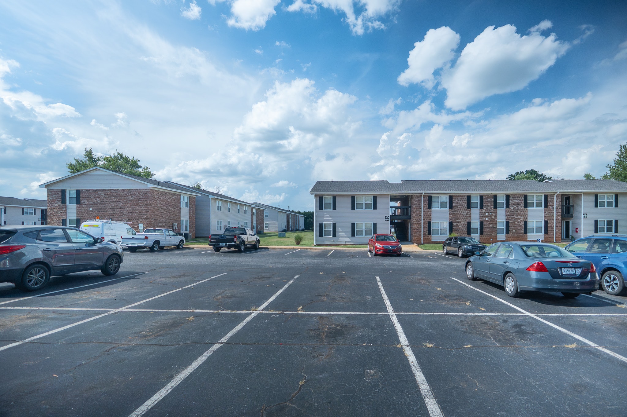 Multifamily real estate investment property with apartment buildings and parking lot, representing Southeast multifamily investment strategy and long-term rental returns.