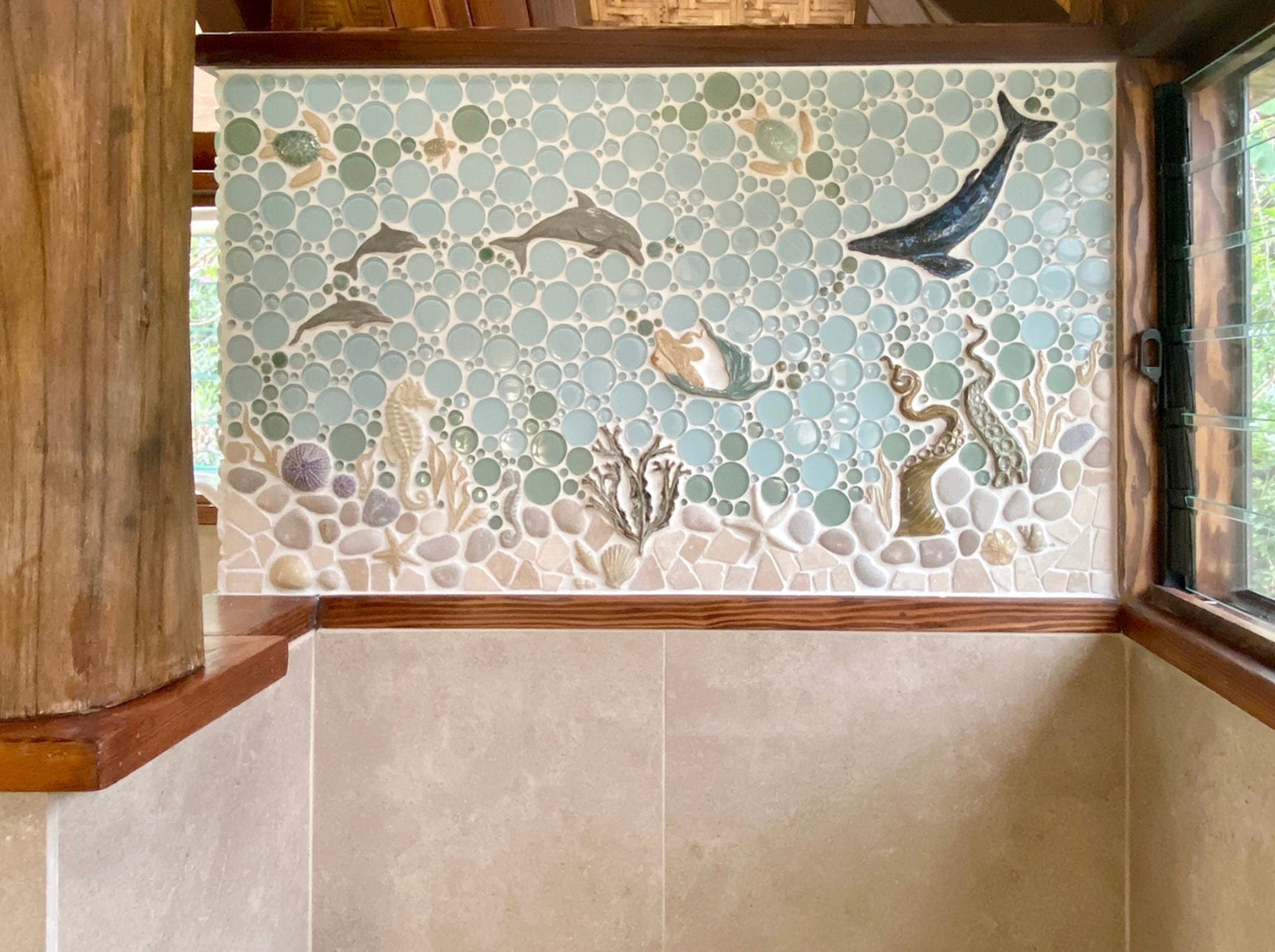 Mosaic tile showing dolphins and whale underwater