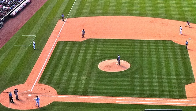 A pitcher with runners on base waiting to deliver a pitch.