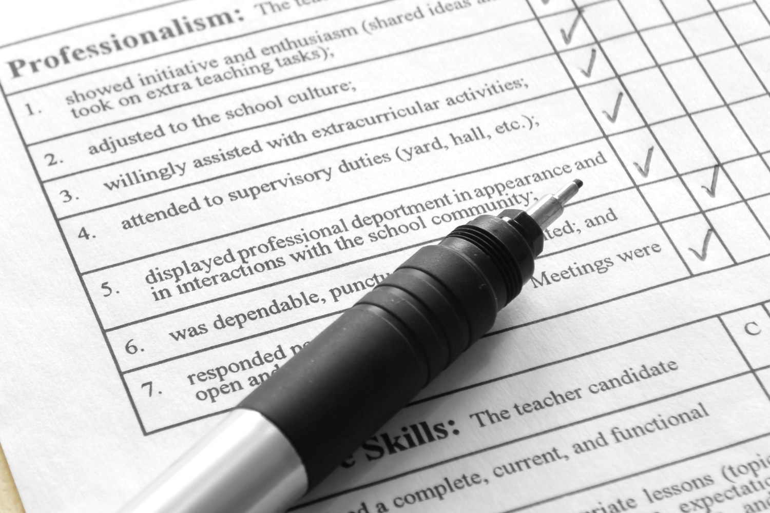 Some self-assessment questions on a piece of paper.