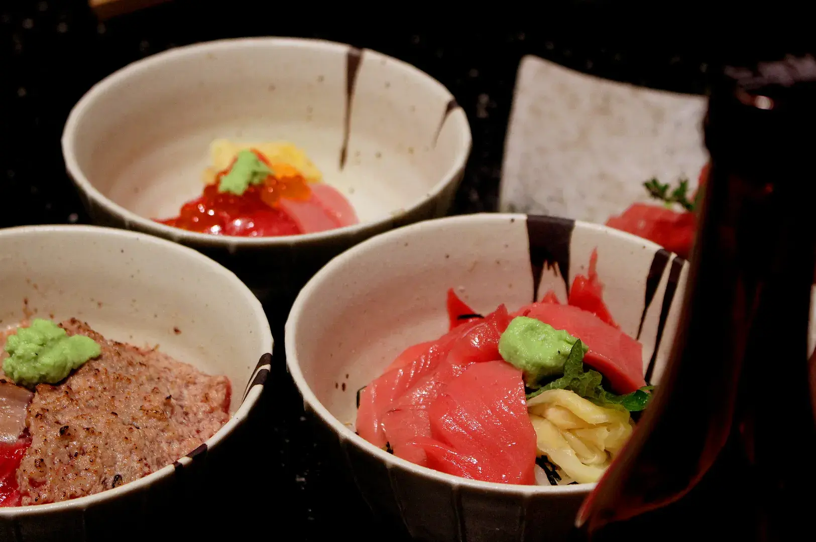 Assorted Japanese sashimi bowls with fresh tuna, salmon, prawns, ikura, and uni at Kuro Maguro Tanjong Pagar