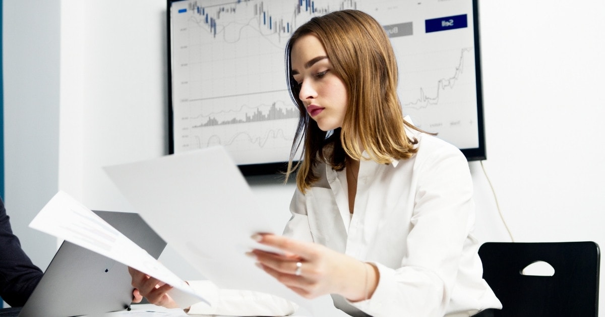 A woman reviewing a file about the FICA tax rate for 2024.