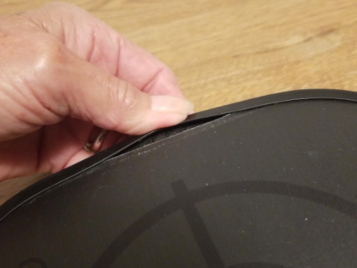 An image showing the rim of a pickleball paddle falling apart.