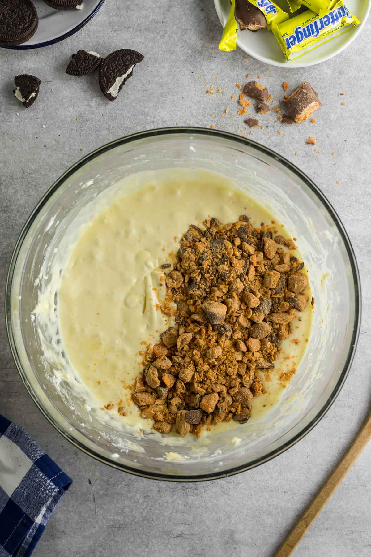 butterfingers added to cheesecake mixture in bowl