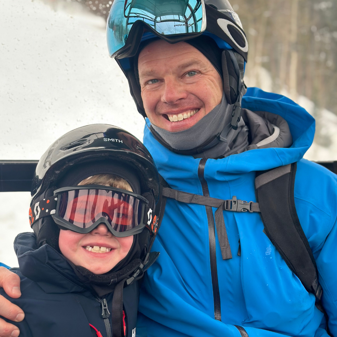 Dad and son skiing