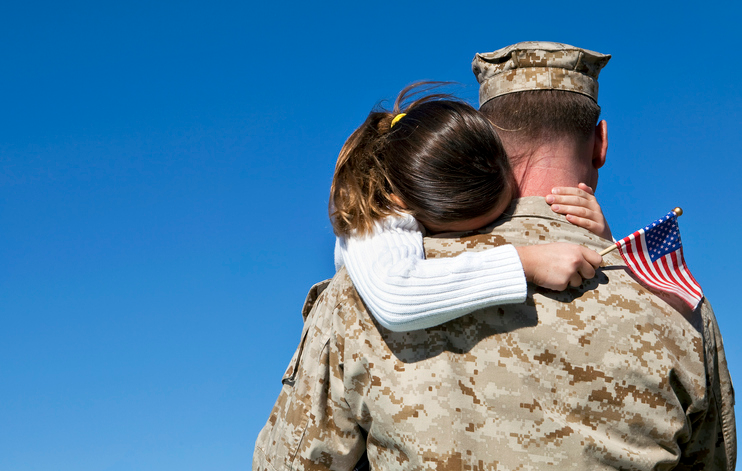 U.S. Veteran carrying his daughter.