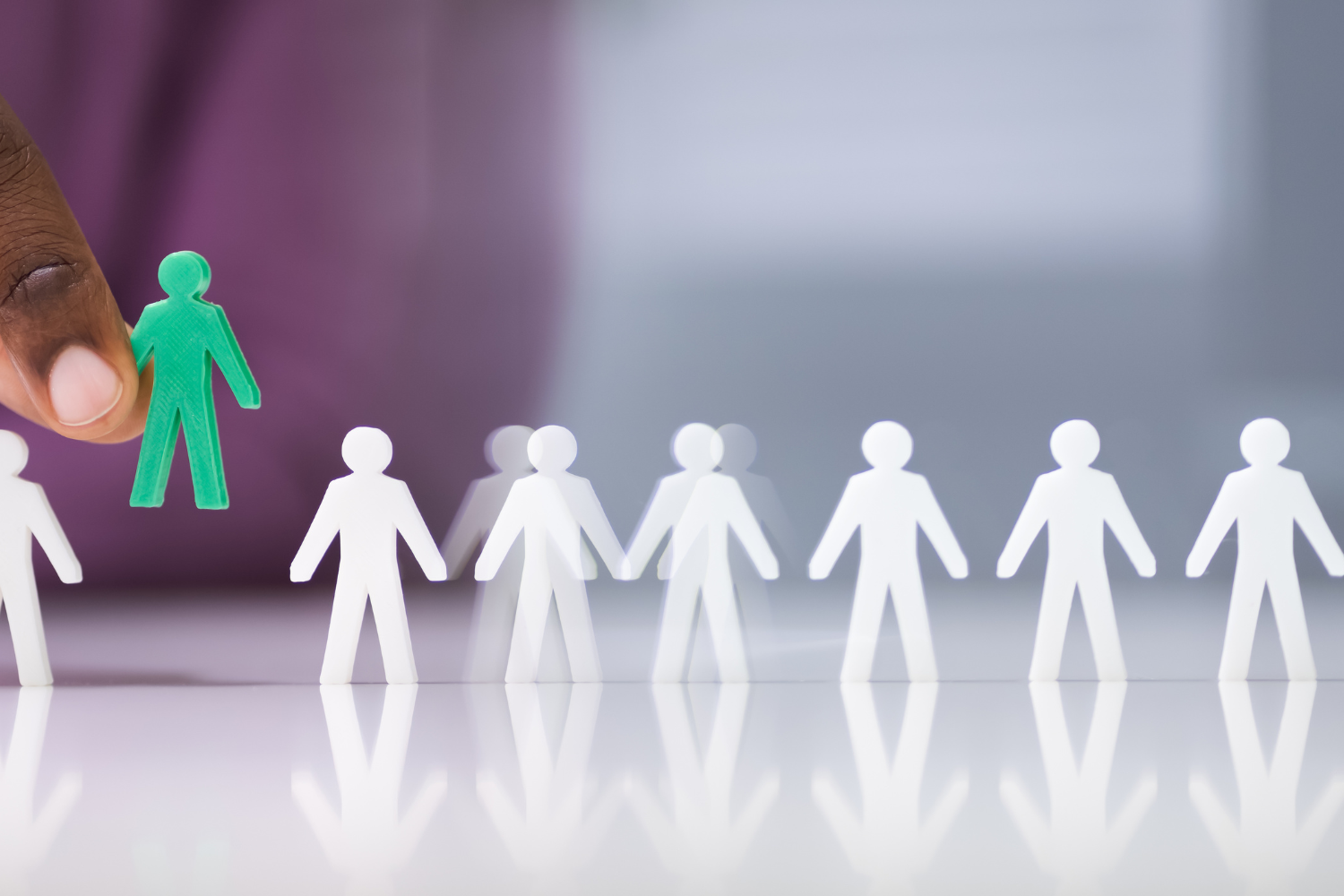 Models of small people, with one special human model in green.