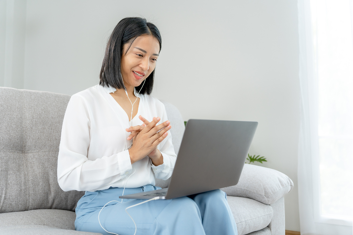 Filipino woman smiling and participating in a virtual interview for a digital marketing role
