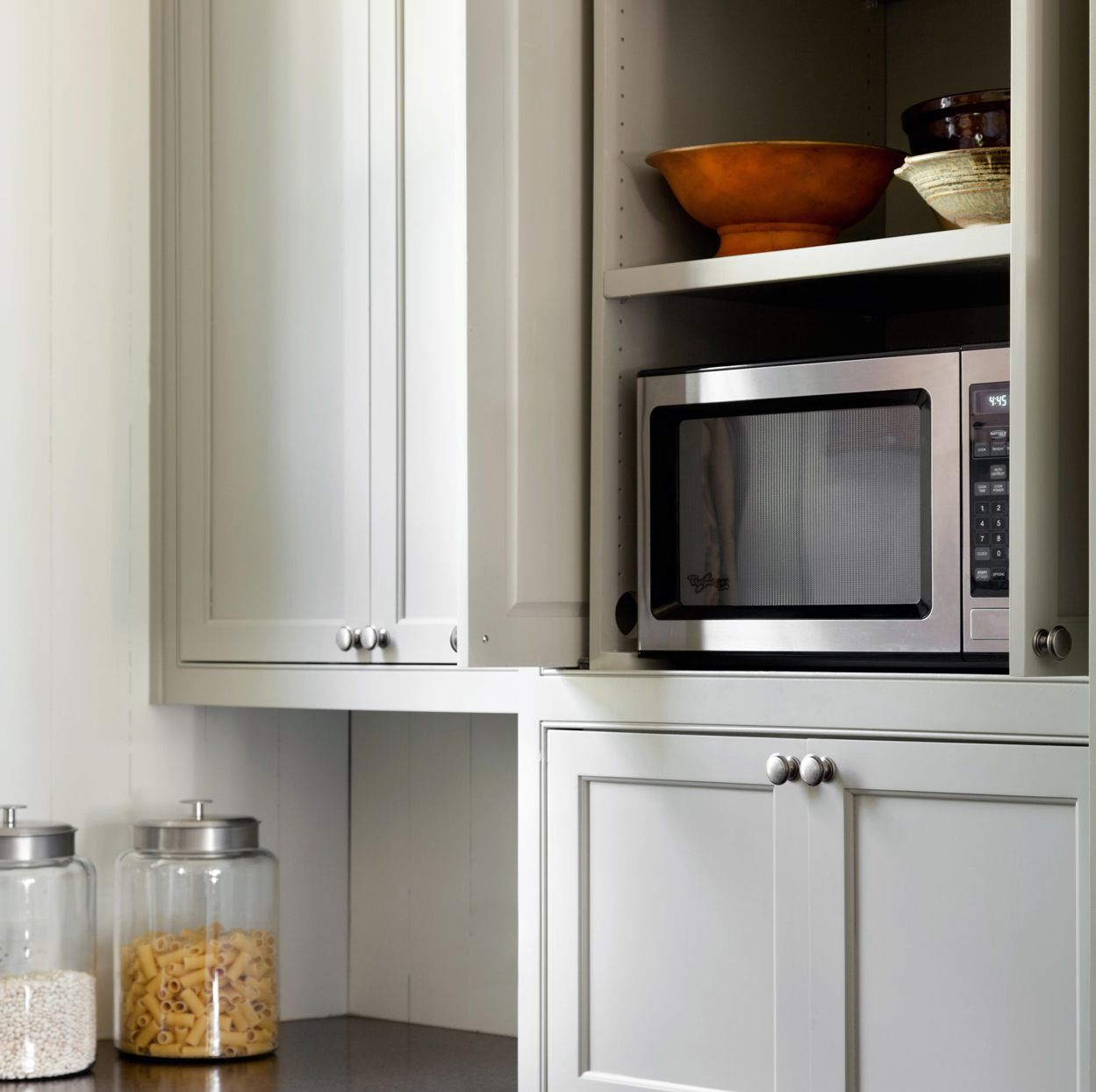 Standard microwave in its own cabinet 