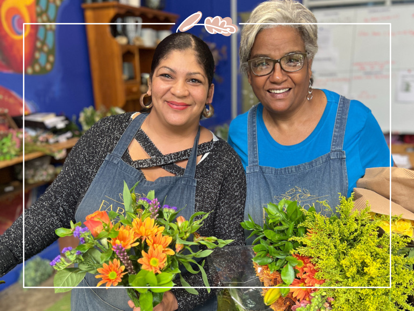 Two florists proudly display colourful flower arrangements at Bunches for Africa in Cape Town, Western Cape highlighting their dedication to creating beautiful bunches for weddings and events. Experience this at Fabulous Flowers and Gifts.