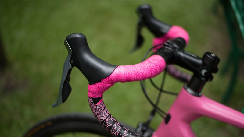 Customized mountain bike used for off-road cycling leaned against a colorful graffiti wall.