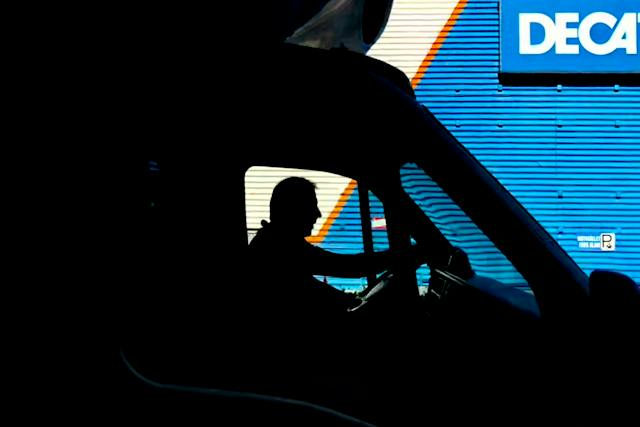 A delivery courier using a GPS device, an example of a telematics suite