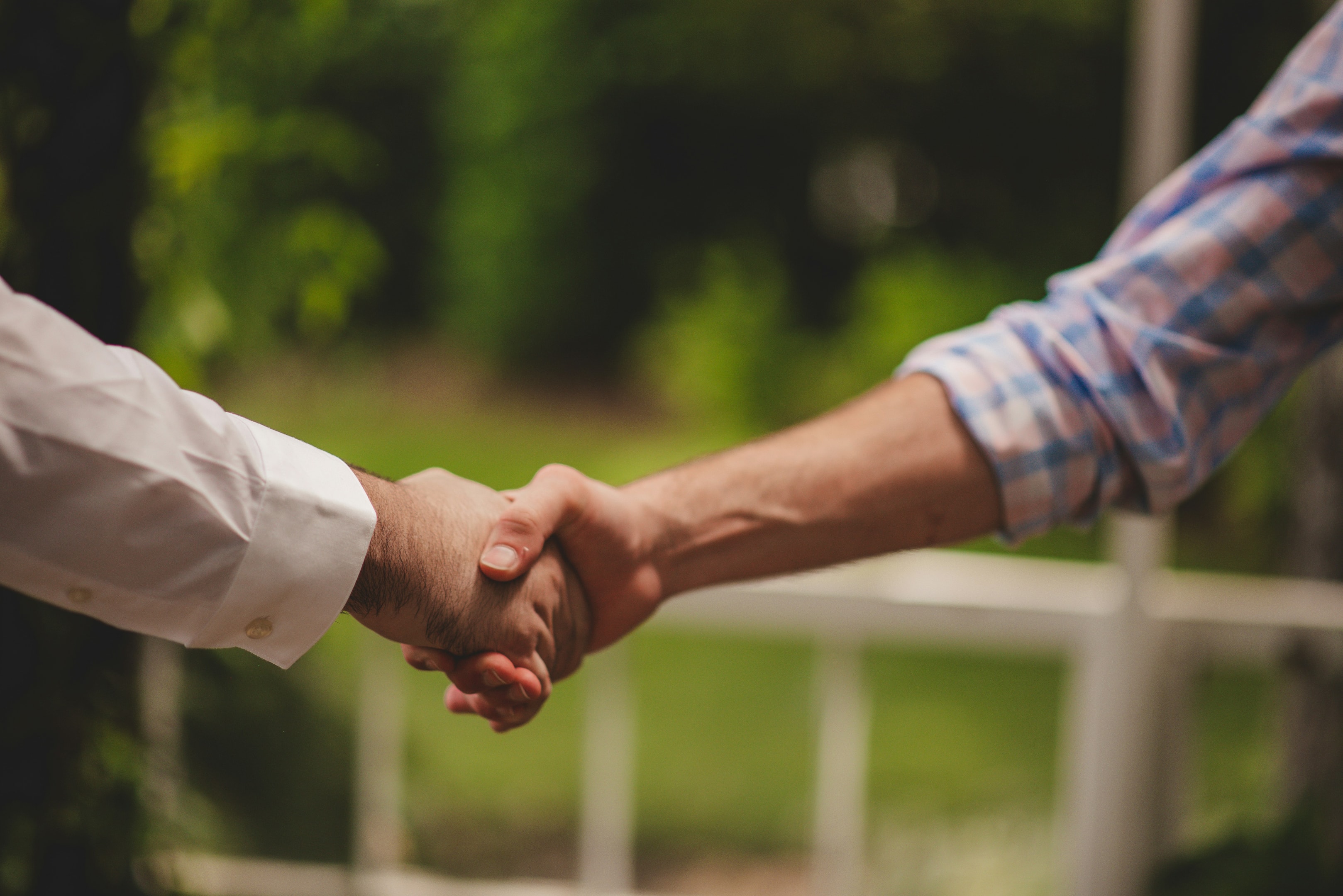 Handshake between wholesaler and end buyer after a successful close of real estate deal.