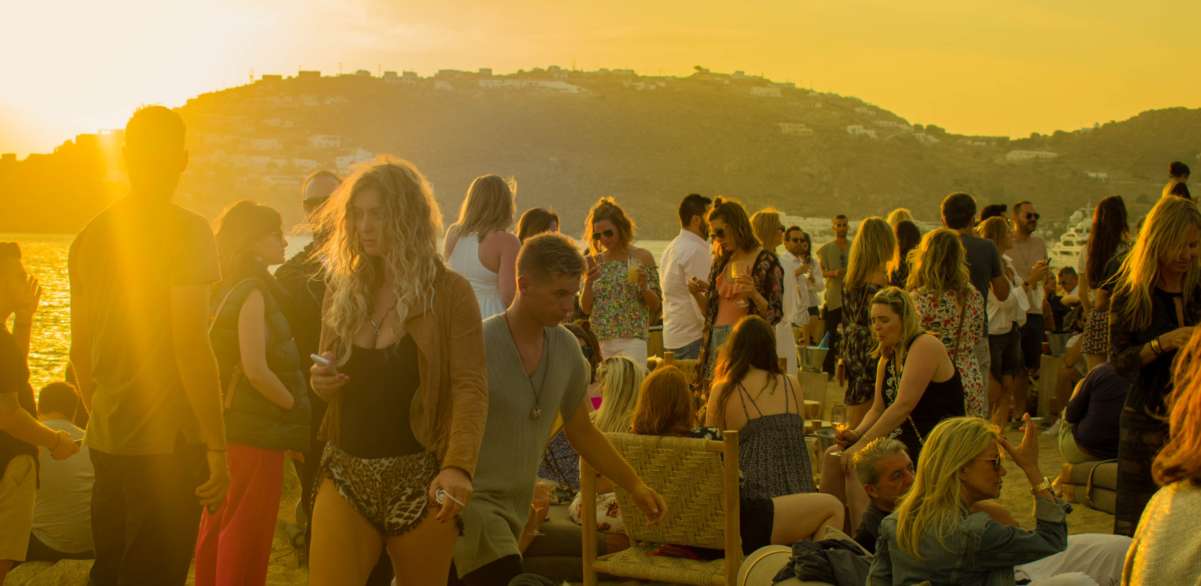 Crowd of people gathering during a sunset