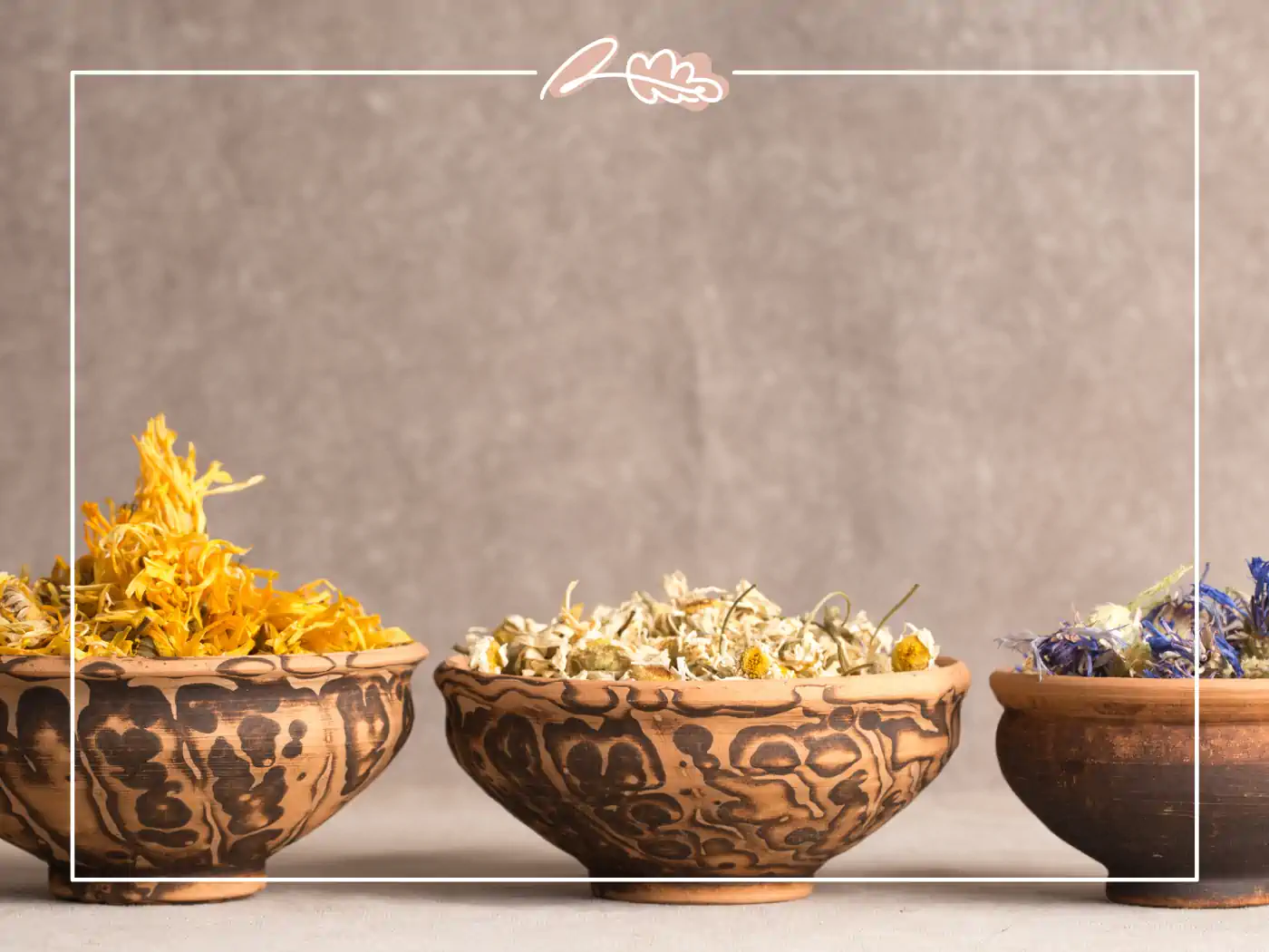 Three rustic bowls filled with various dried flowers in shades of yellow, white, and blue, arranged in a row. Fabulous Flowers and Gifts.