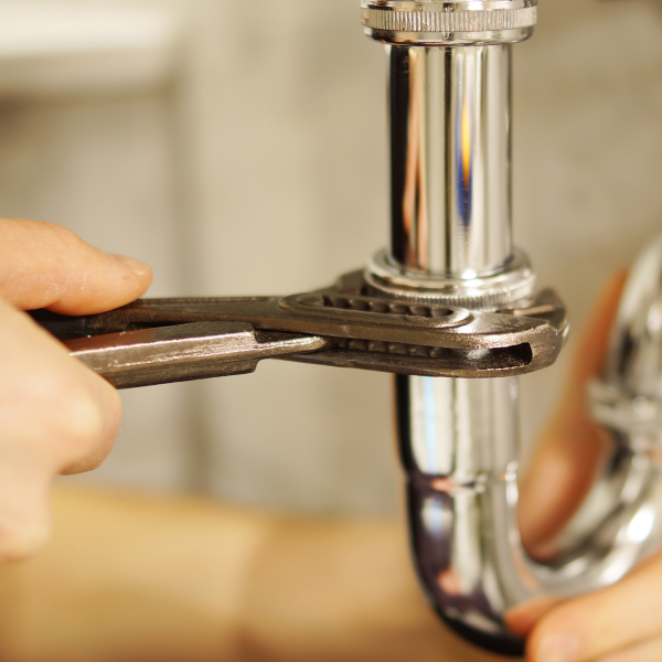 An image showing a plumber using advanced tools for repair.