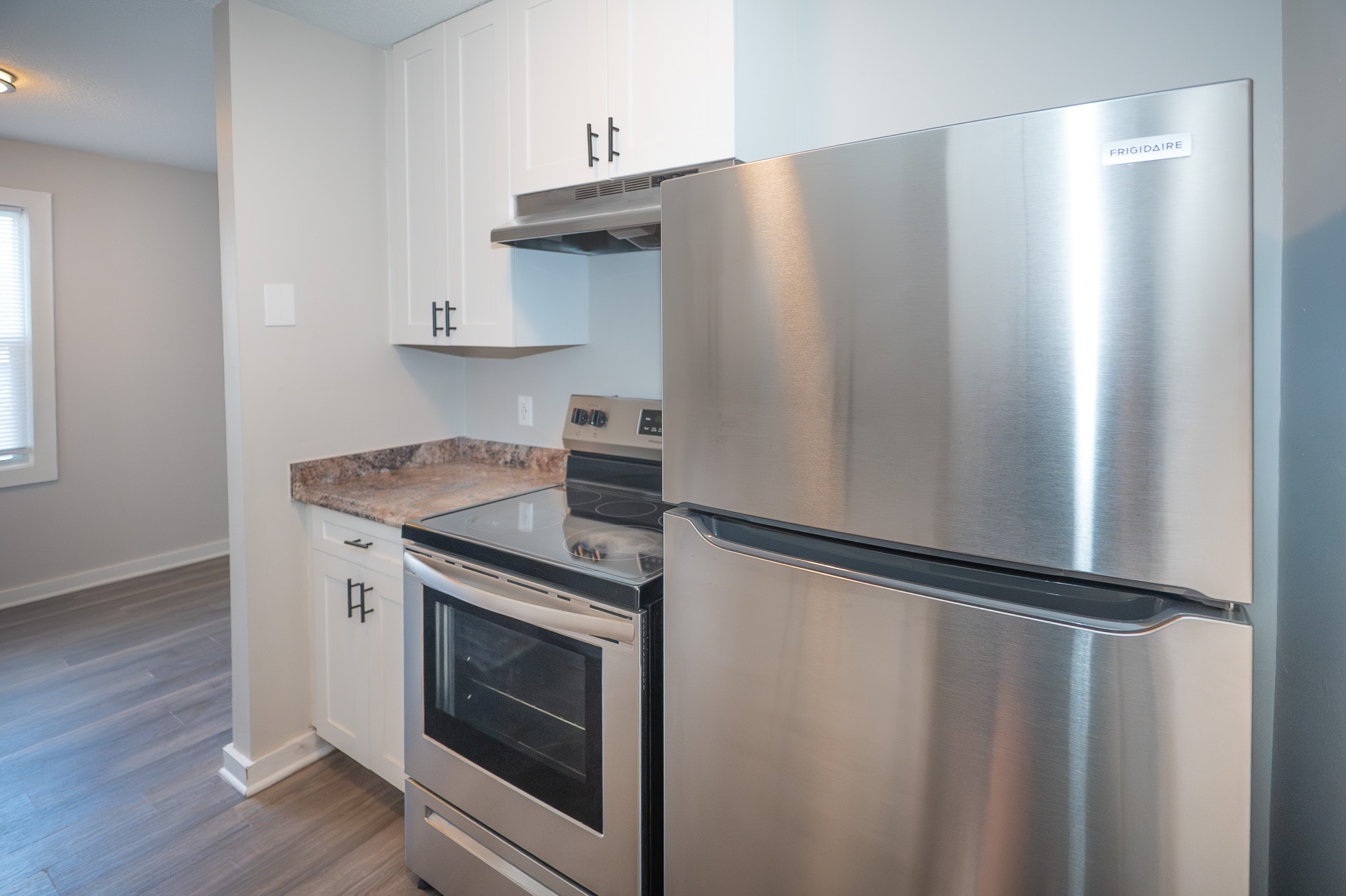 A modern apartment kitchen features sleek stainless steel appliances and updated finishes, highlighting the appeal of multifamily real estate investments and the growing renter demand for quality rental housing. This inviting space reflects the potential for strong rental income and successful multifamily investing.