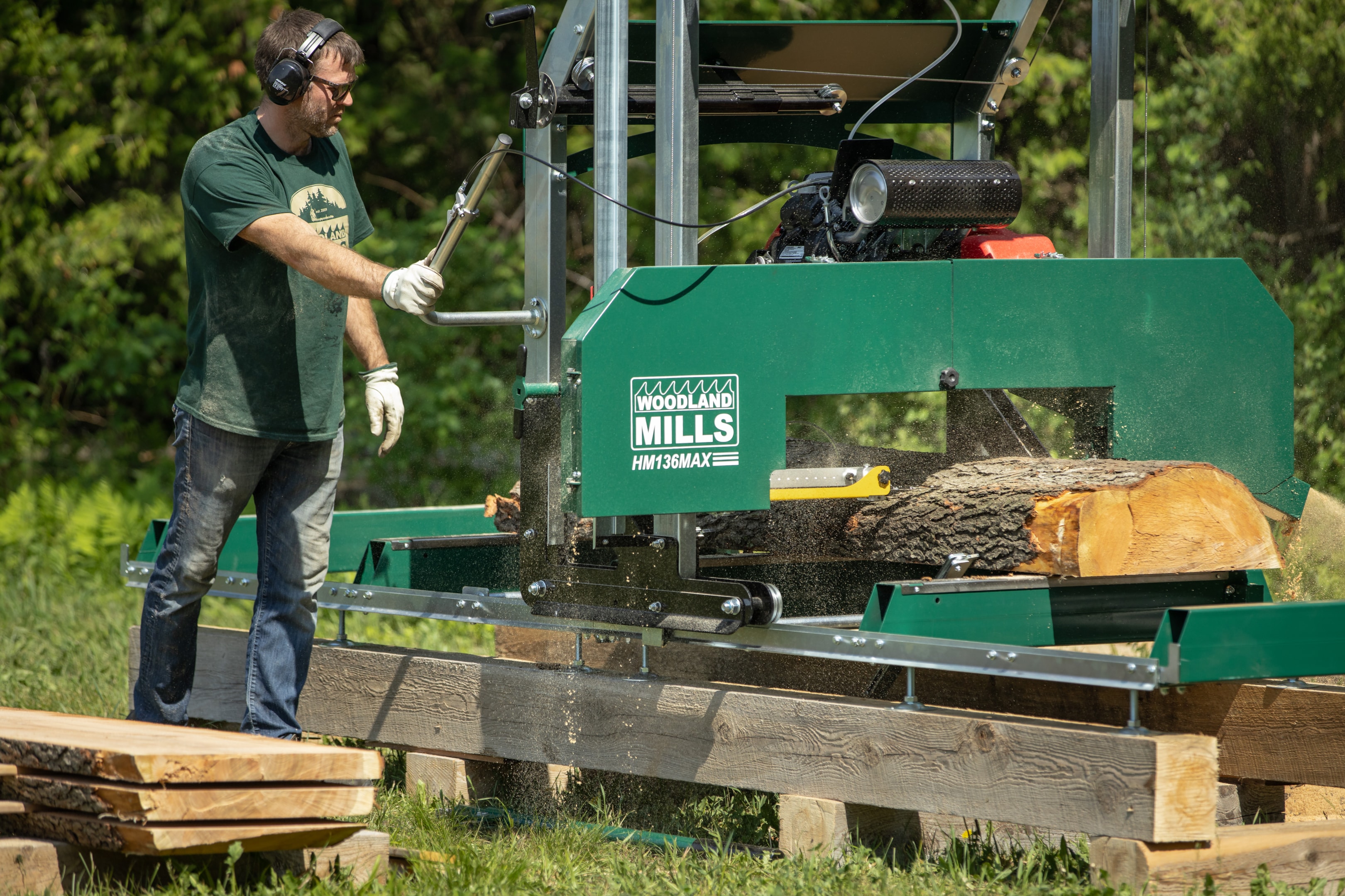 A sawyer milling wood with a Woodland Mills HM136MAX sawmill. 