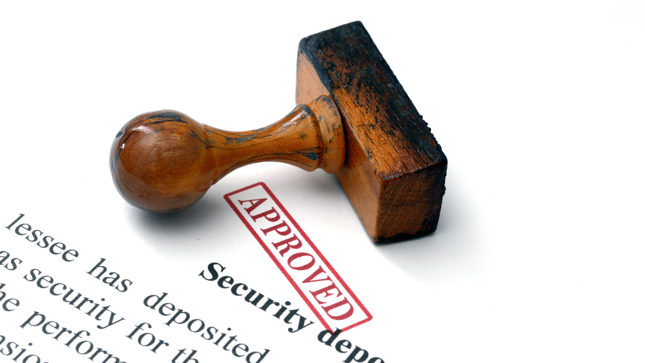 Rental agreement document with a traditional security deposit clause, stamped 'Approved' with a wooden stamp
