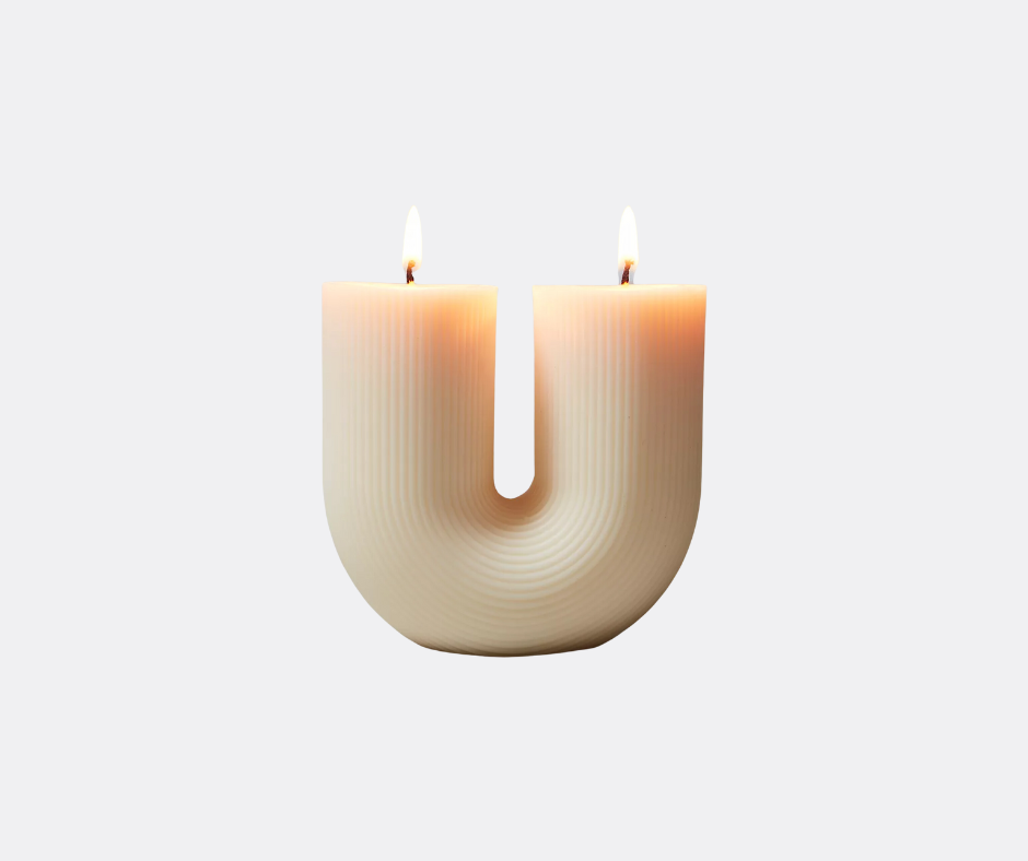 This cream-colored sculptural candle is high on our list of host gifts. Add it to gift baskets with matches and cloches.