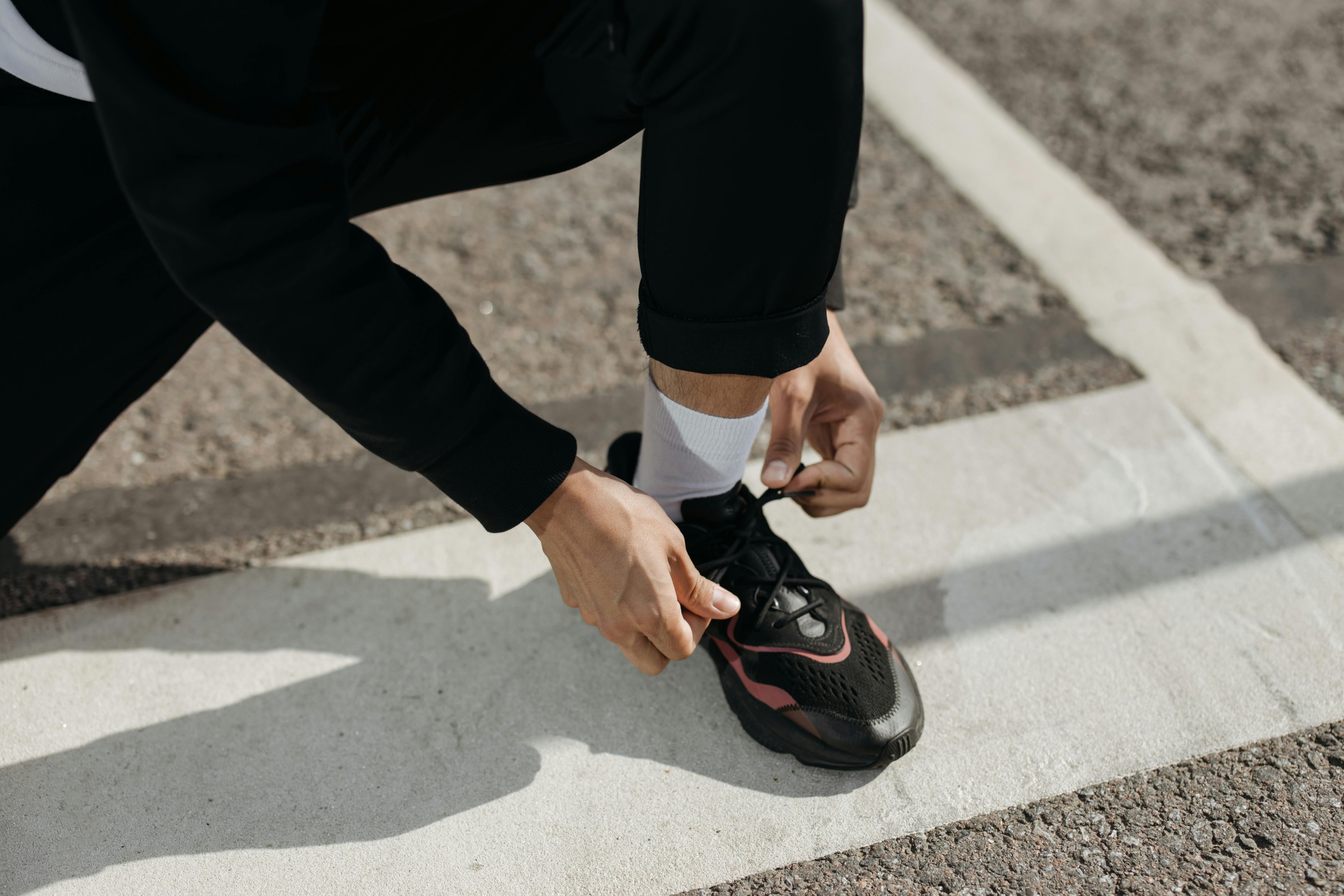 Photo by cottonbro studio: https://www.pexels.com/photo/a-person-wearing-black-pants-tying-the-lace-of-the-sneaker-he-is-wearing-5319319/