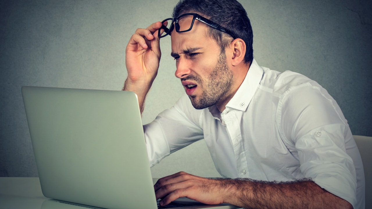 confused man using laptop