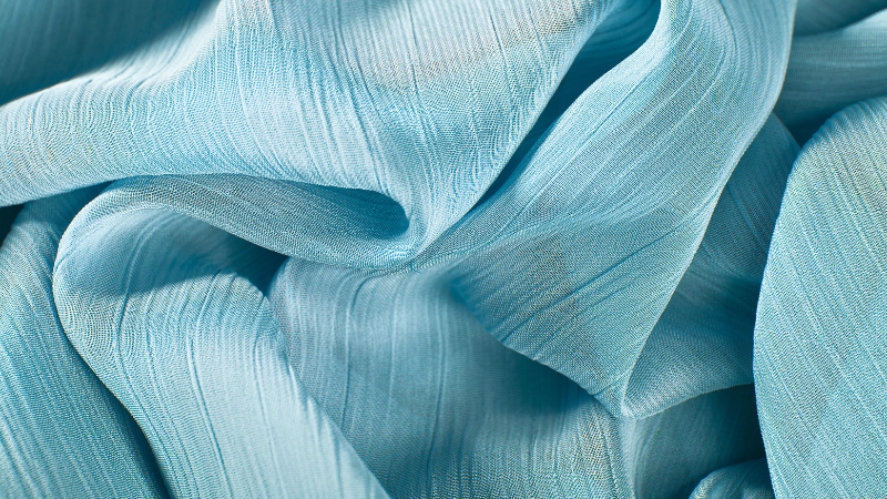 A close-up view of a blue chiffon fabric