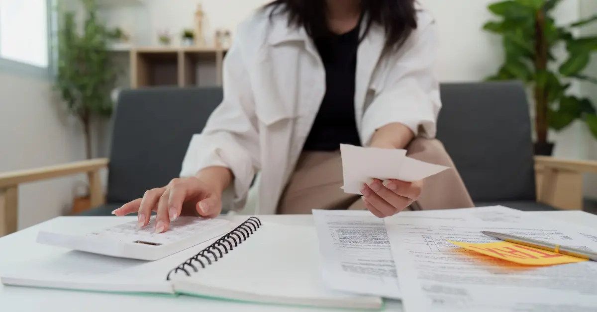 OnlyFans creator organizing tax paperwork based on 2026 income tax brackets.