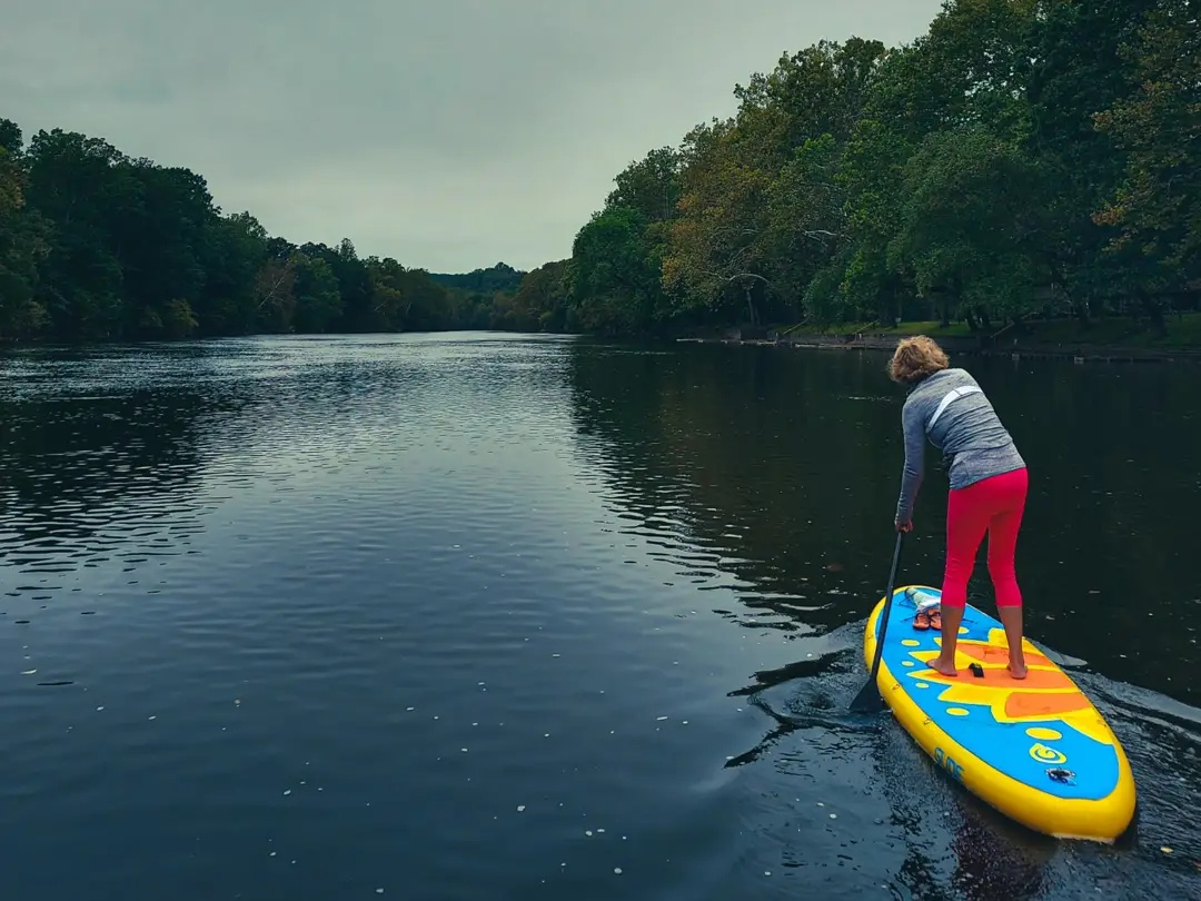 woman paddling an inflatable paddle board