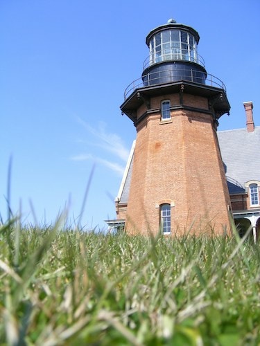Block Island lighthouse in warmer weather, close to beautiful beaches