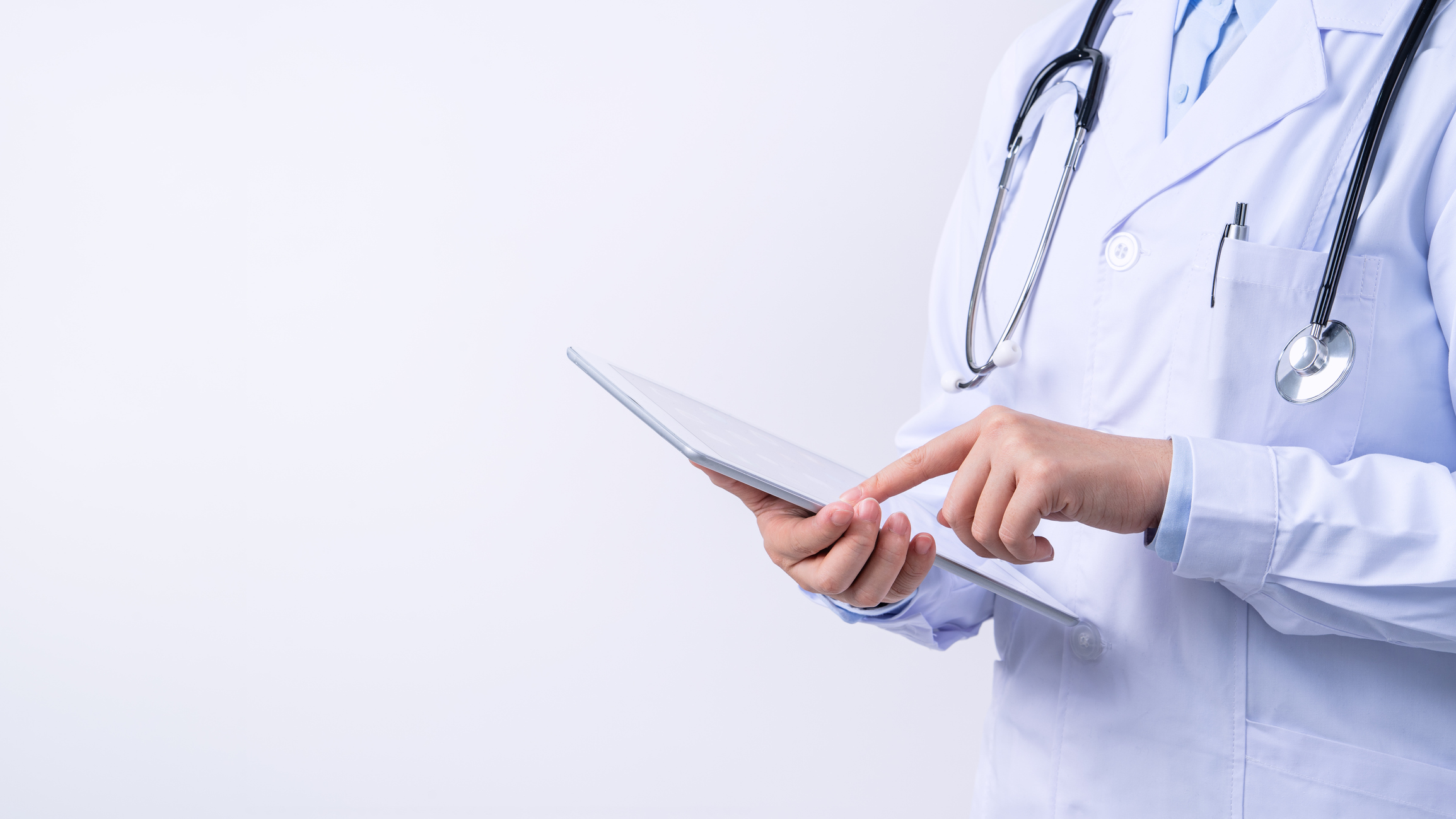 An image of a doctor with stethoscipe around her neck studying a clipboard in her hand. 