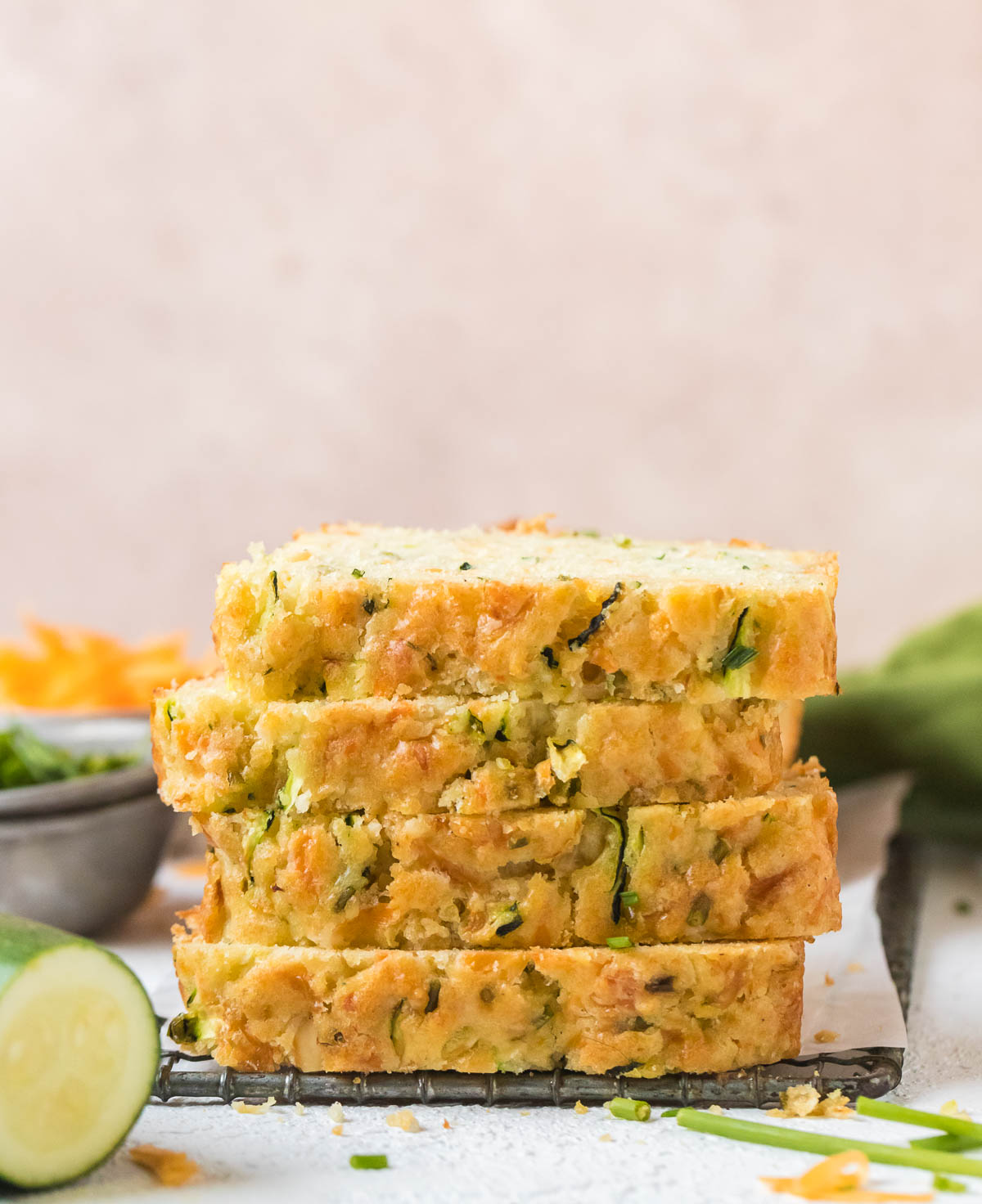 four slices of zucchini cheddar bread stacked on top of each other