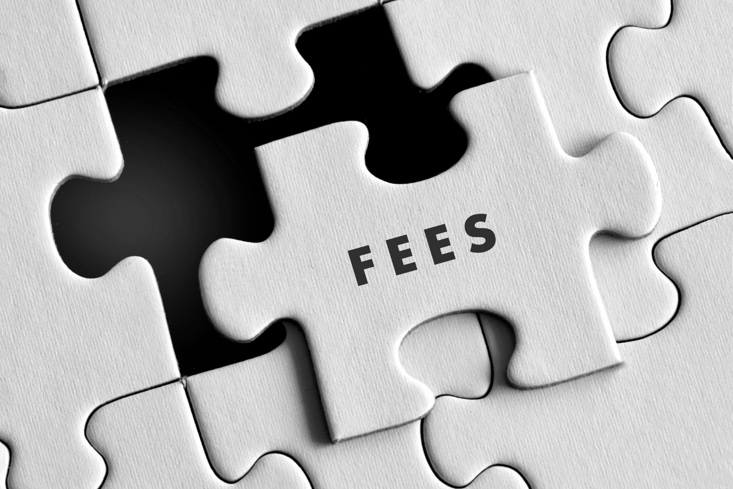 Puzzle piece with the word "fees" on it.