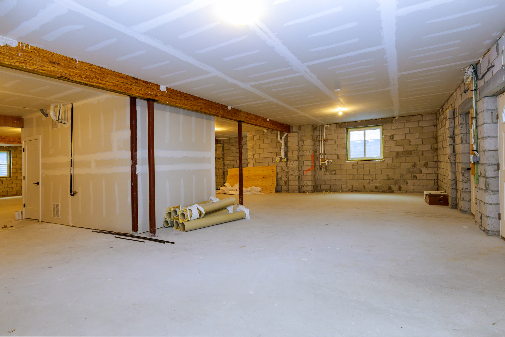 New open floorplan in basement with an engineered beam and lally column posts