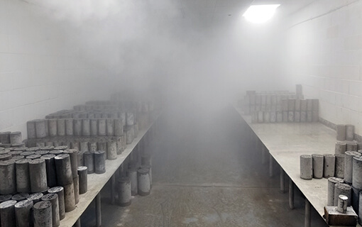 A concrete core sample being cured in a controlled environment