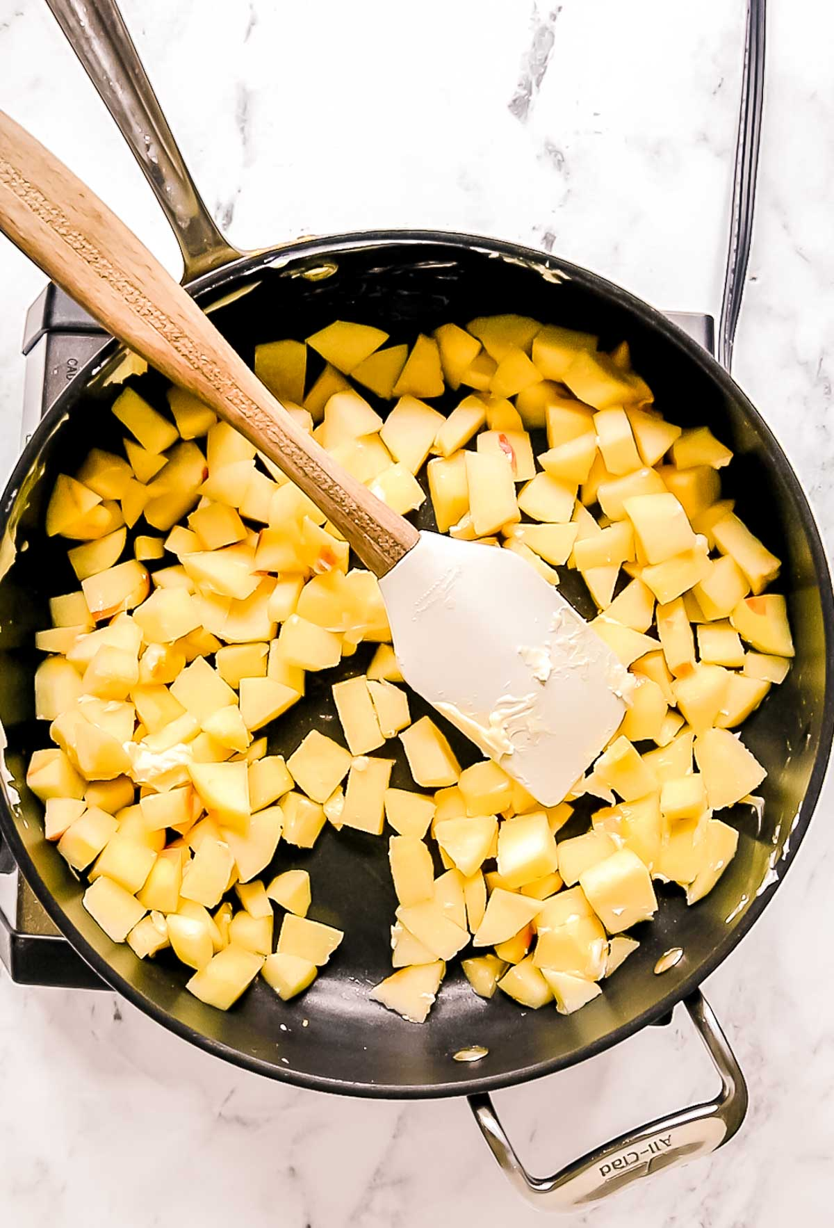 diced apples in saucepan with spatula
