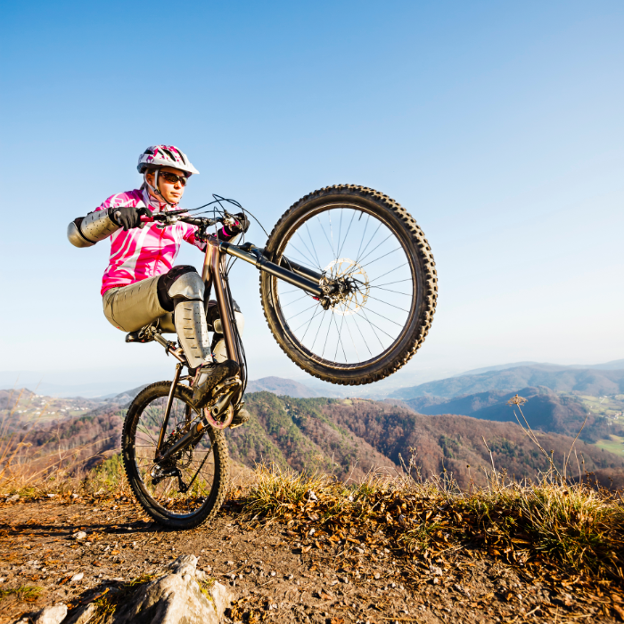 A mountain biker discovering their balance point on a manual machine