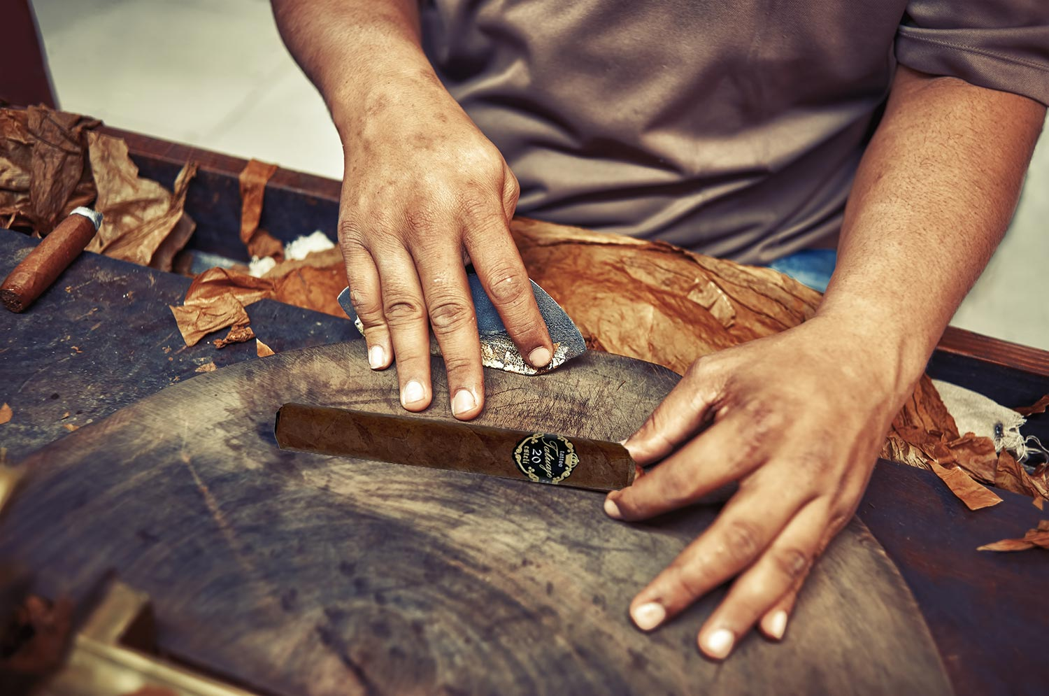 A factory worker rolling a Tatuaje 20th Grande Merveille cigar