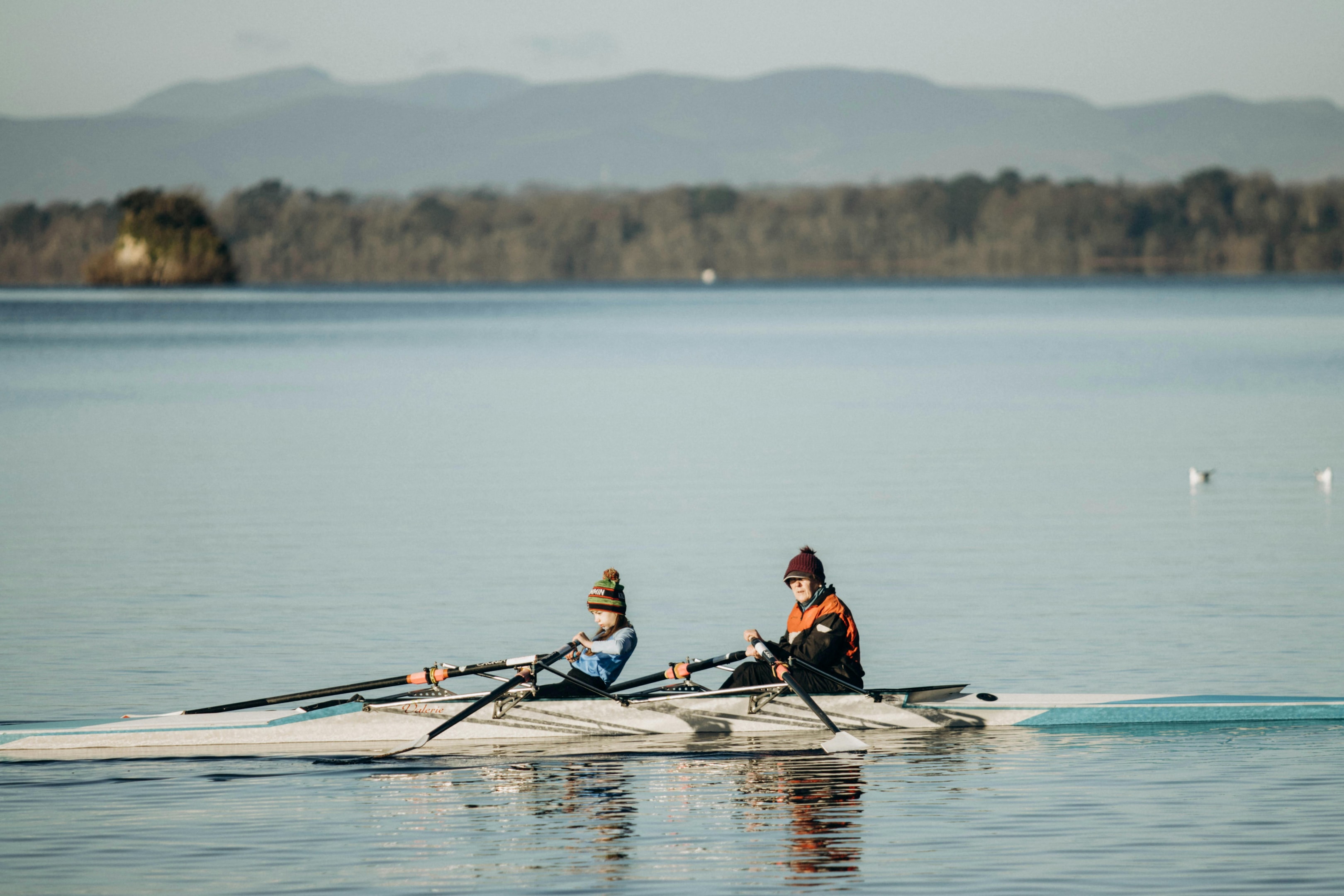 Couple rowing on a calm lake