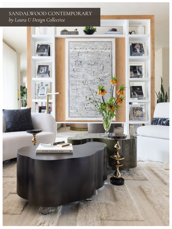 a black and white living room with a white sofa and black sculptural table with a fireplace in the background