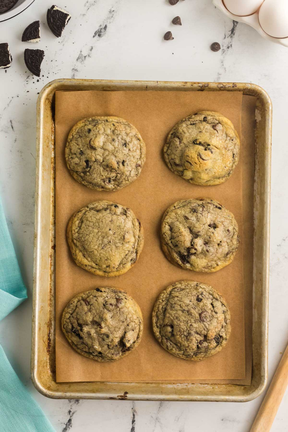six baked oreo cheesecake cookies on cookie sheet