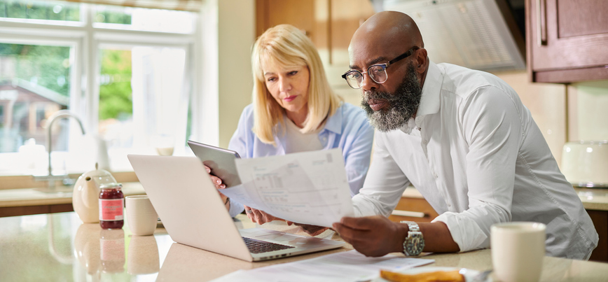 Two pensioners looking at pension reform plans