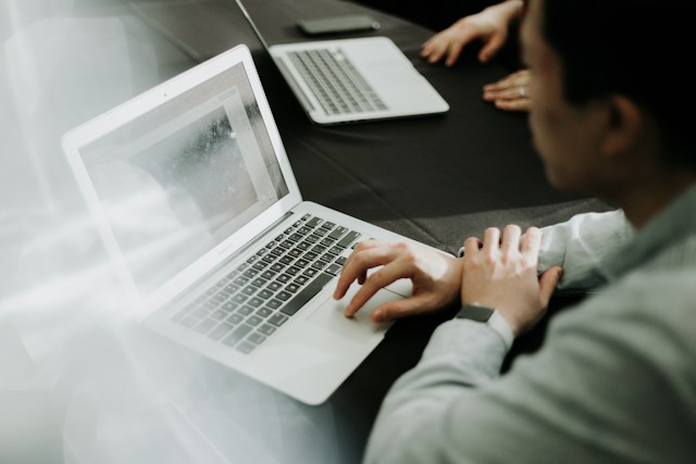 a fleet manager analyzing reports on a laptop